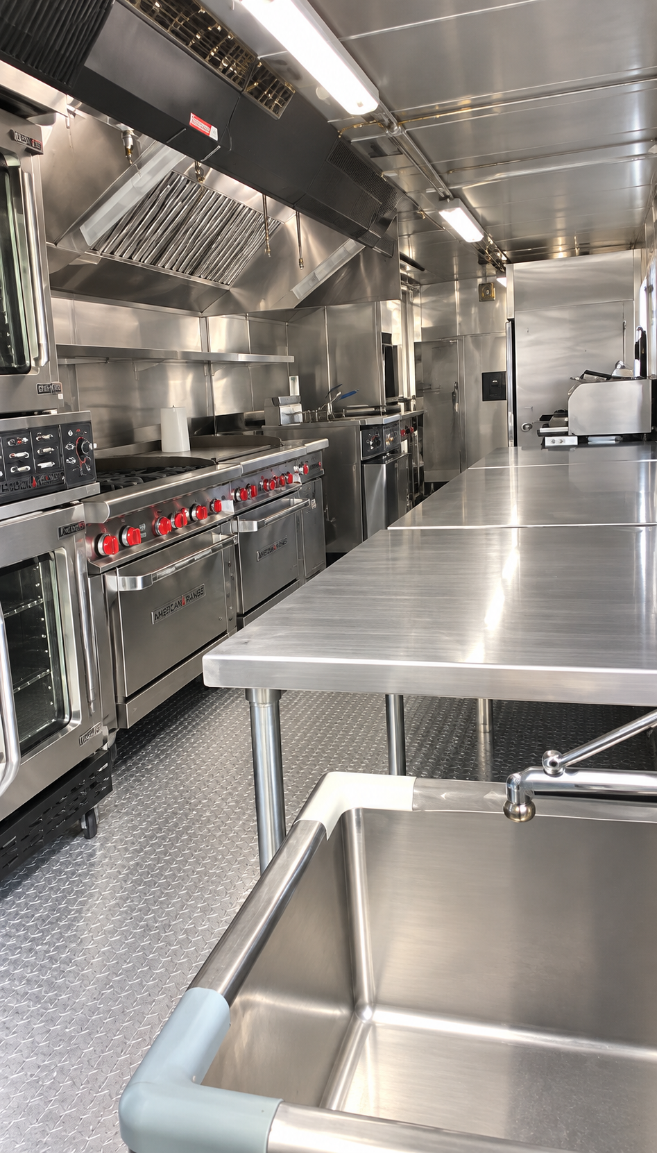 Commercial mobile kitchen interior with stainless steel cooking and preparation equipment